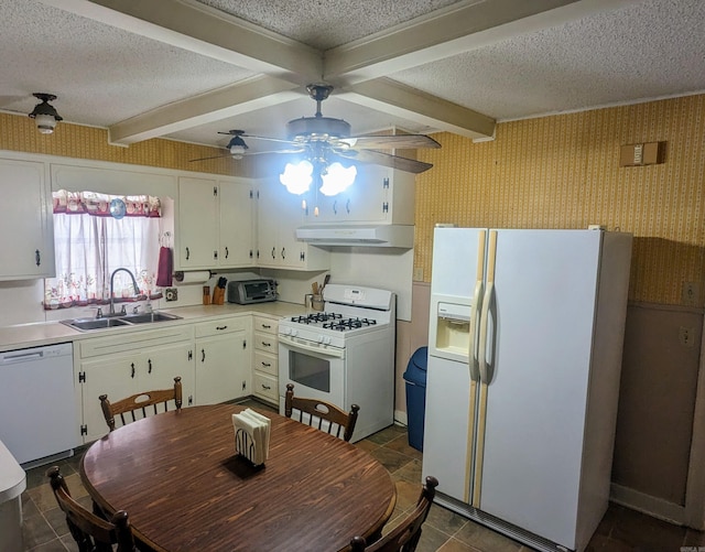 kitchen featuring beam ceiling, white appliances, sink, and ceiling fan