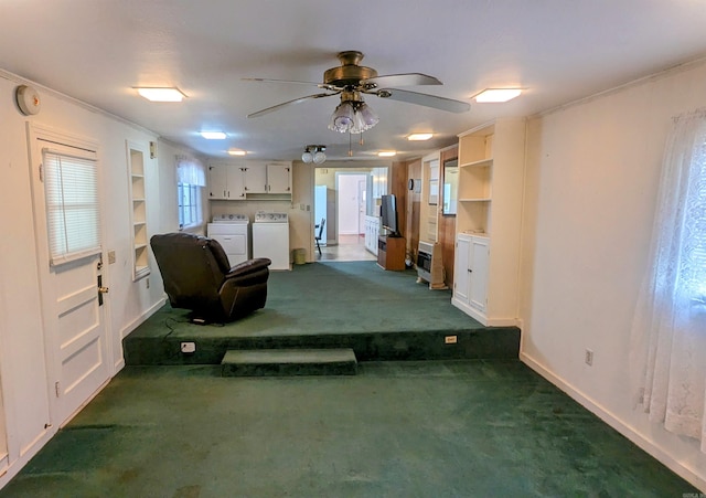 interior space featuring dark carpet, separate washer and dryer, ceiling fan, and ornamental molding