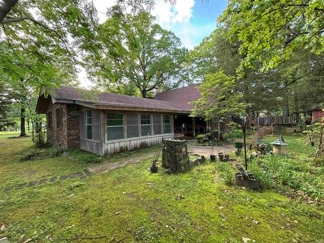 rear view of house featuring a yard