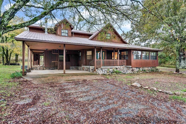 back of property with covered porch