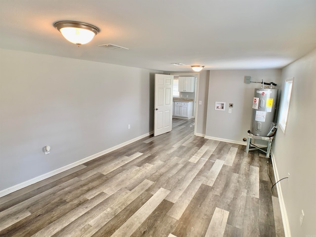 interior space with light hardwood / wood-style flooring and water heater