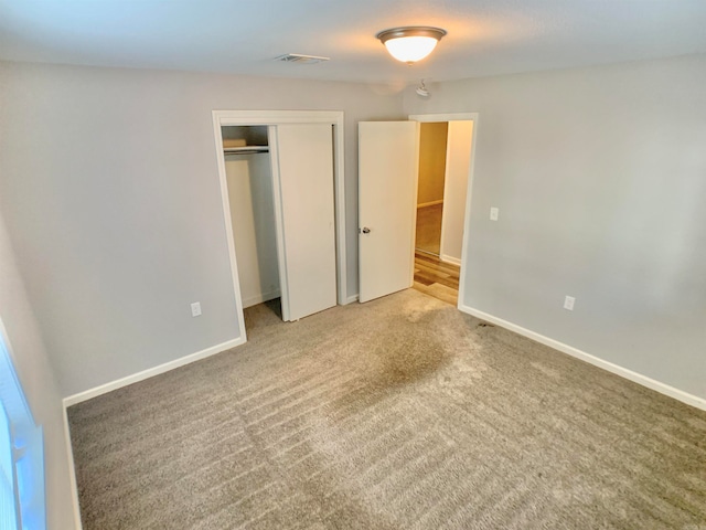 unfurnished bedroom with carpet floors and a closet