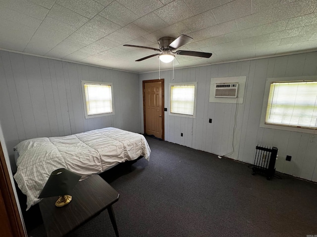 carpeted bedroom with ceiling fan and an AC wall unit