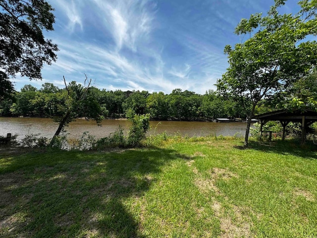 view of yard featuring a gazebo and a water view