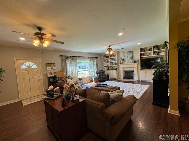 living room featuring ceiling fan, dark hardwood / wood-style flooring, and built in shelves