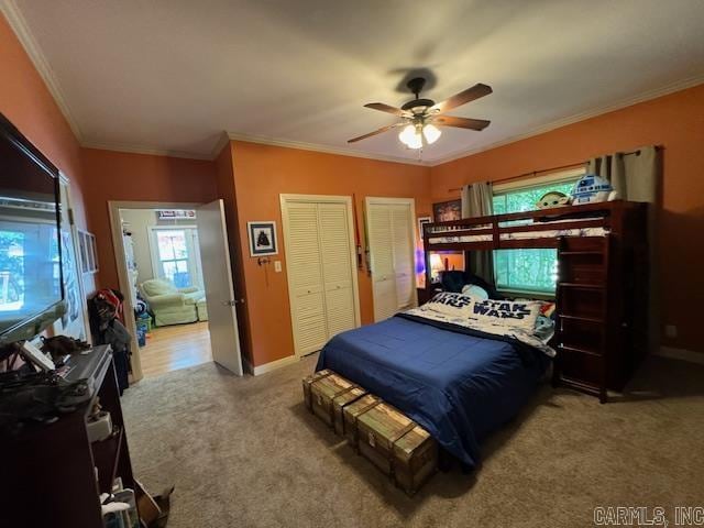 bedroom with ornamental molding, carpet, and ceiling fan