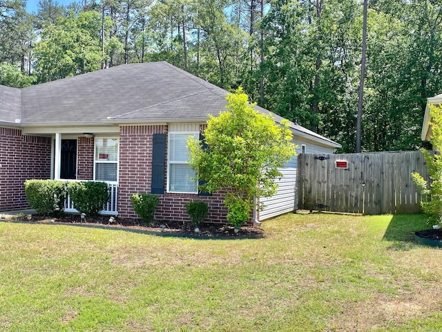 view of side of property with a yard