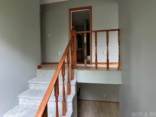 stairs featuring hardwood / wood-style flooring