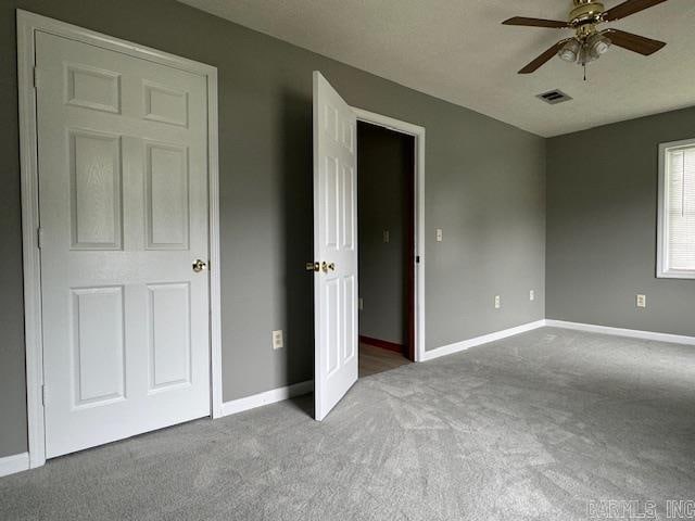 unfurnished bedroom with carpet floors and ceiling fan