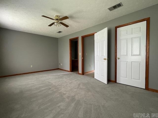 unfurnished bedroom with ceiling fan, a textured ceiling, and carpet floors