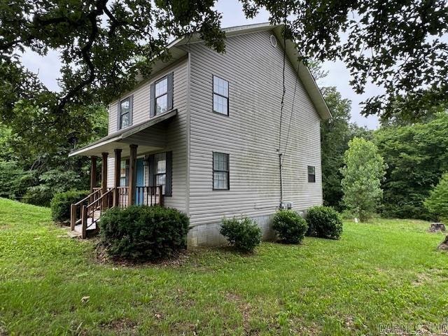 view of side of home featuring a lawn