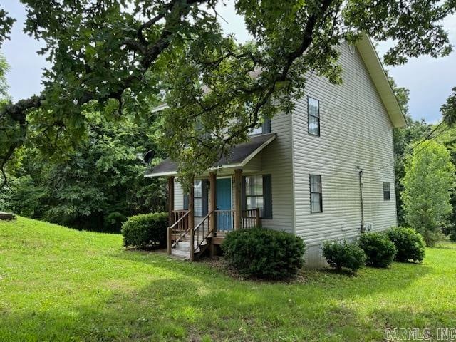 view of side of property featuring a yard