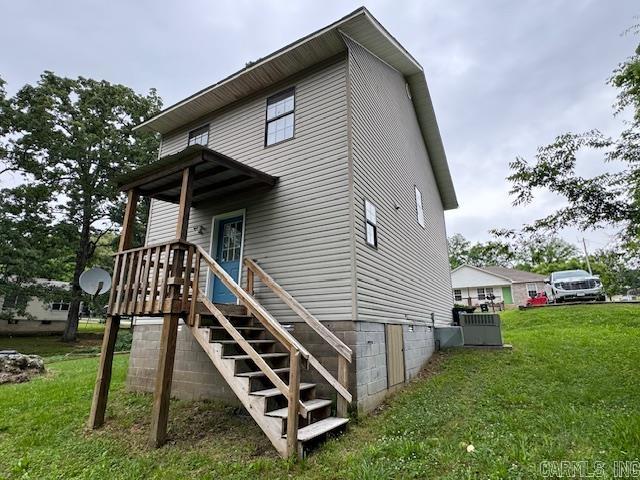 rear view of house with a yard