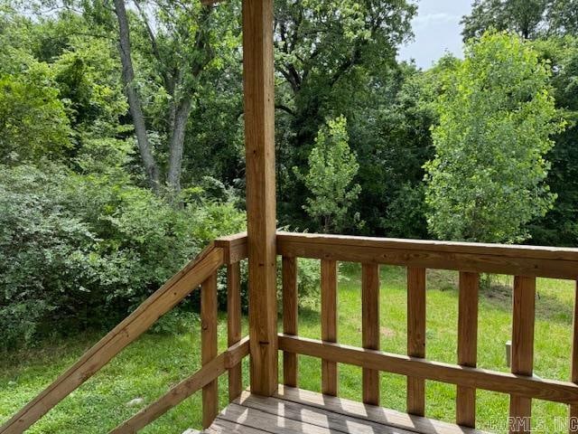 wooden terrace with a lawn