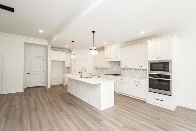 kitchen featuring black microwave, oven, sink, and light hardwood / wood-style flooring