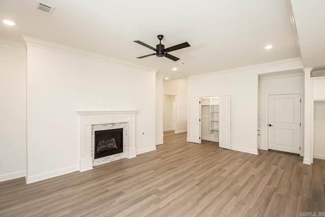 unfurnished living room with a fireplace, ceiling fan, hardwood / wood-style floors, and ornamental molding