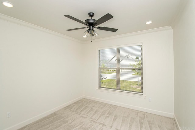 carpeted empty room with ceiling fan and ornamental molding