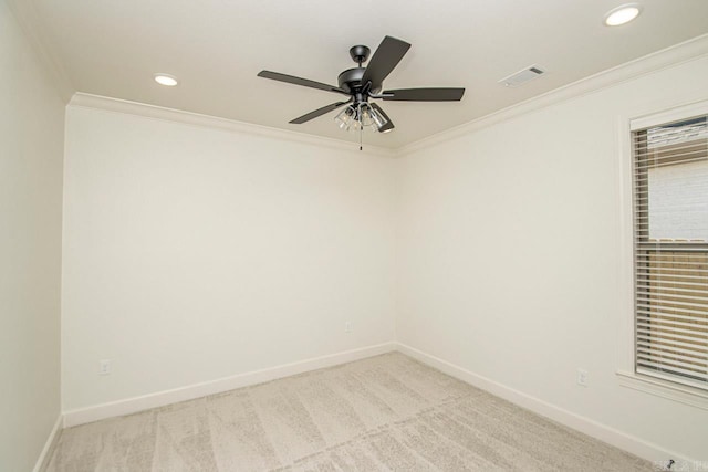 carpeted spare room with ceiling fan and ornamental molding