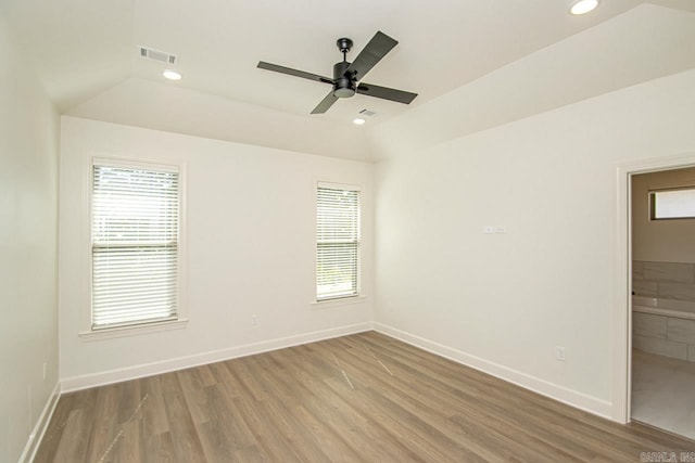 spare room featuring lofted ceiling, wood-type flooring, and ceiling fan