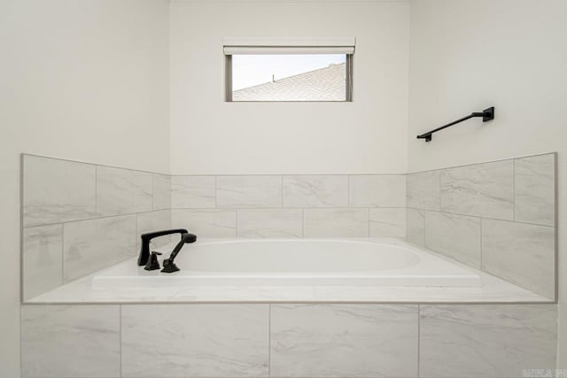 bathroom featuring tiled bath