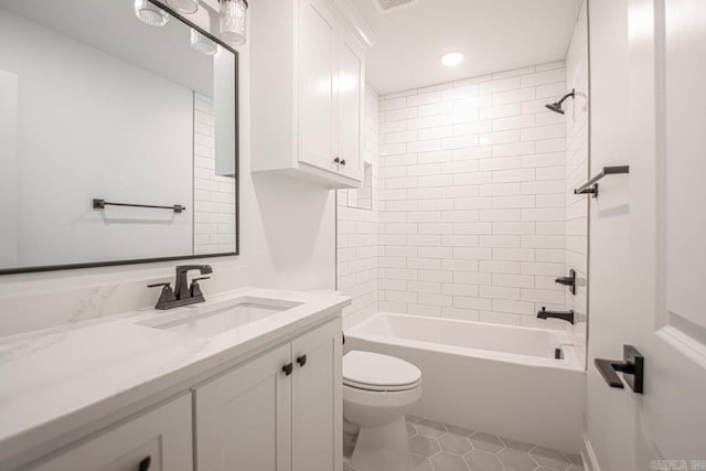 full bathroom featuring tile flooring, tiled shower / bath combo, vanity, and toilet