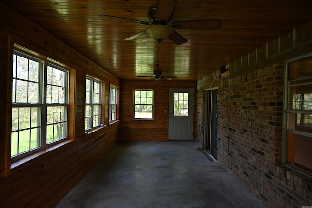 unfurnished sunroom with wooden ceiling and ceiling fan