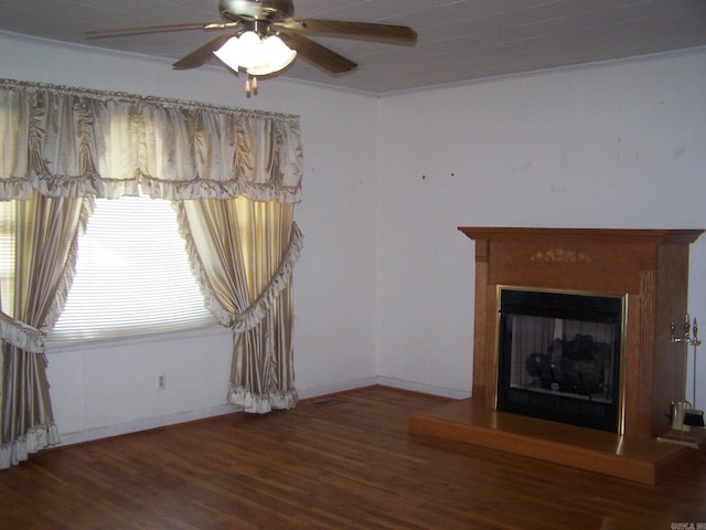 unfurnished living room featuring ceiling fan and dark hardwood / wood-style flooring