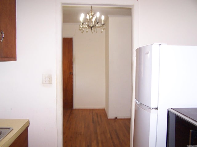 interior space with a notable chandelier and wood-type flooring