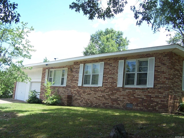 ranch-style house featuring a garage, central AC, and a front lawn