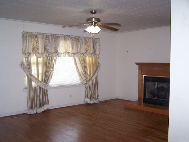 unfurnished living room featuring dark hardwood / wood-style floors and ceiling fan