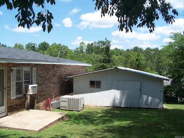 exterior space featuring a lawn, a patio, and central air condition unit