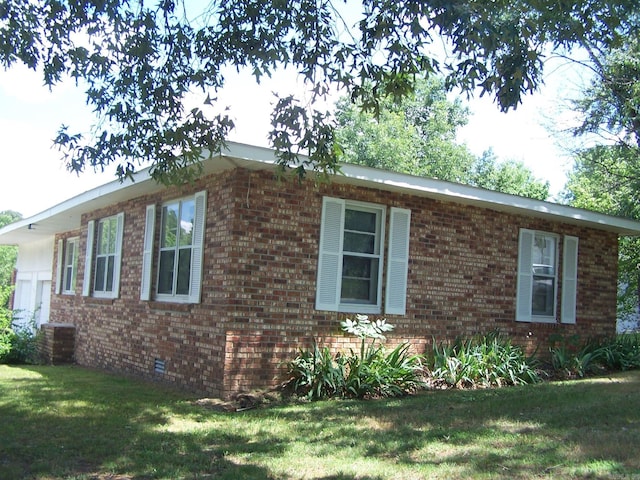 view of home's exterior with a yard and central air condition unit