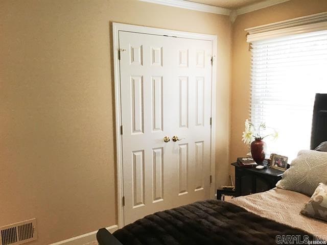 bedroom featuring a closet and ornamental molding