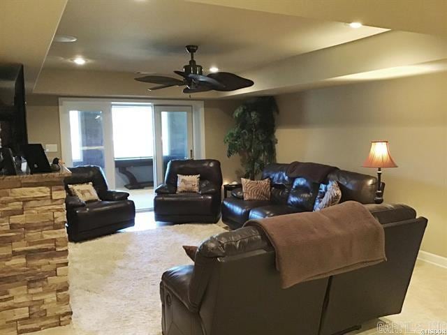 living room featuring ceiling fan and light colored carpet