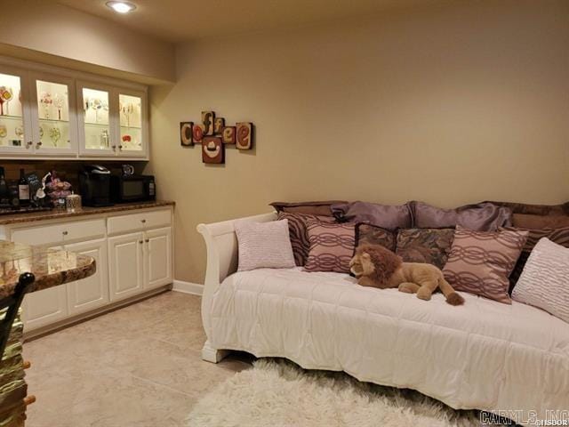 bedroom with light tile patterned floors