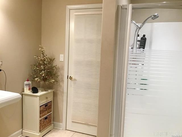 bathroom with tile patterned flooring and a shower