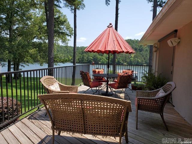 deck featuring a water view and a lawn
