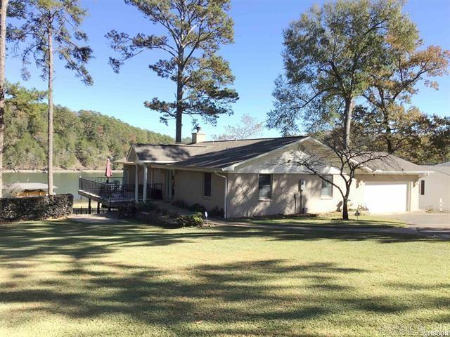 view of front facade featuring a water view, a front yard, and a garage