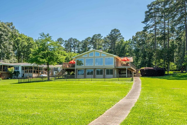 back of property featuring a yard and a deck