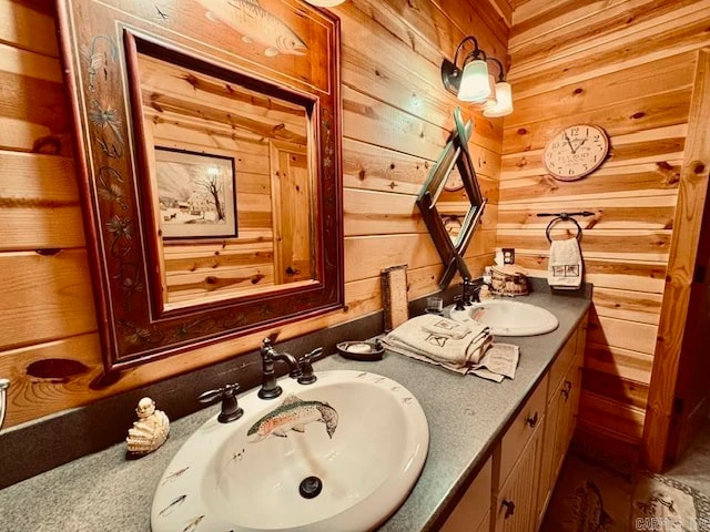 bathroom with dual bowl vanity and wooden walls