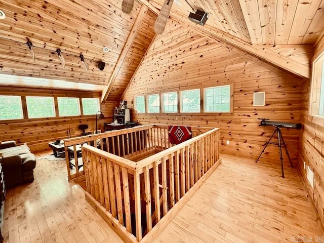 interior space featuring beamed ceiling, high vaulted ceiling, light hardwood / wood-style floors, and wood ceiling