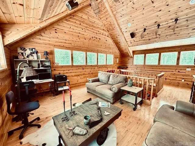 living room featuring beamed ceiling, plenty of natural light, wood ceiling, and light hardwood / wood-style flooring