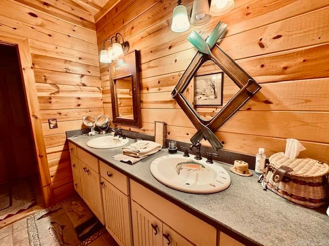 bathroom featuring wooden walls, oversized vanity, and double sink