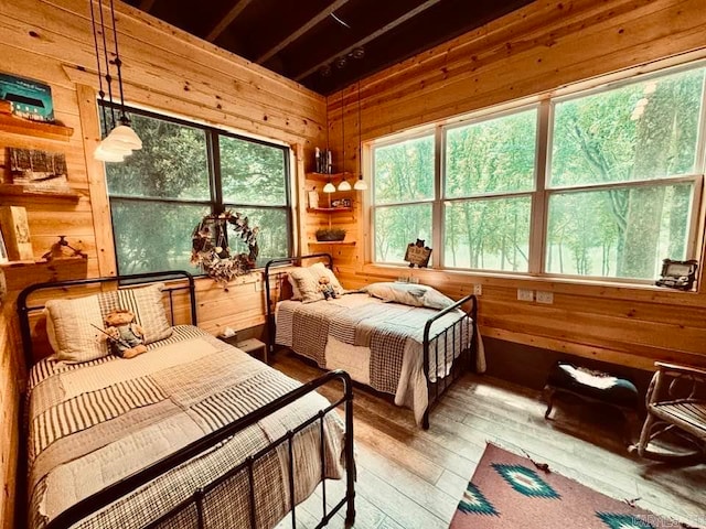 bedroom featuring wooden walls and wood-type flooring