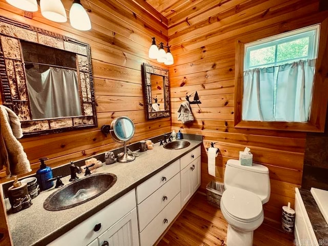 bathroom featuring hardwood / wood-style floors, dual vanity, wood walls, wood ceiling, and toilet