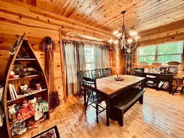 dining room featuring light hardwood / wood-style floors, a notable chandelier, and wooden ceiling