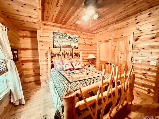 bedroom with wood-type flooring, wooden walls, and wooden ceiling