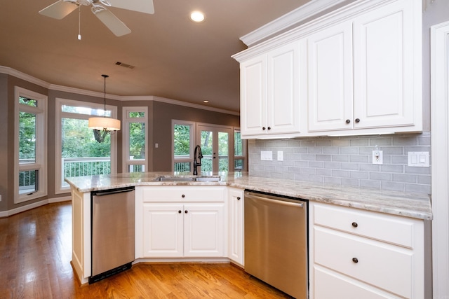 kitchen featuring white cabinets, stainless steel dishwasher, light wood-type flooring, and kitchen peninsula