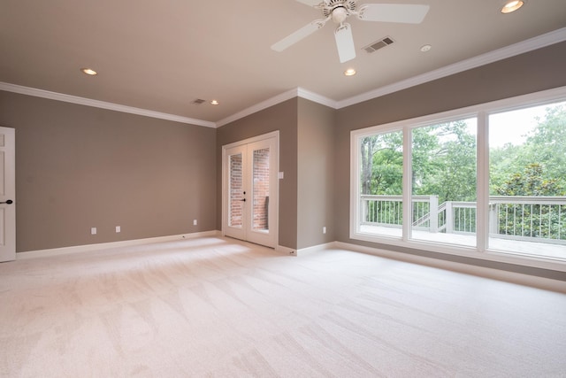 unfurnished room with ornamental molding, ceiling fan, and light colored carpet