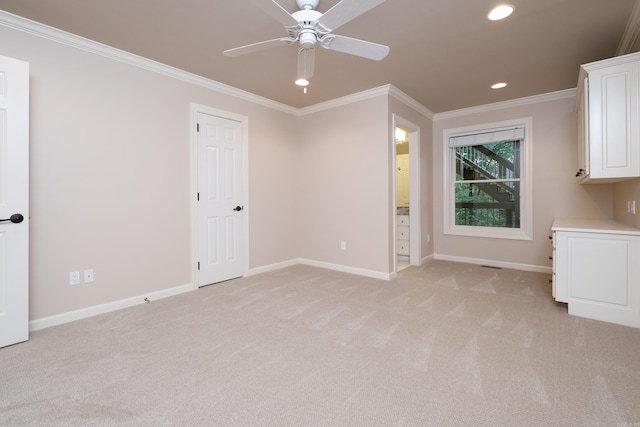 interior space with ornamental molding and ceiling fan